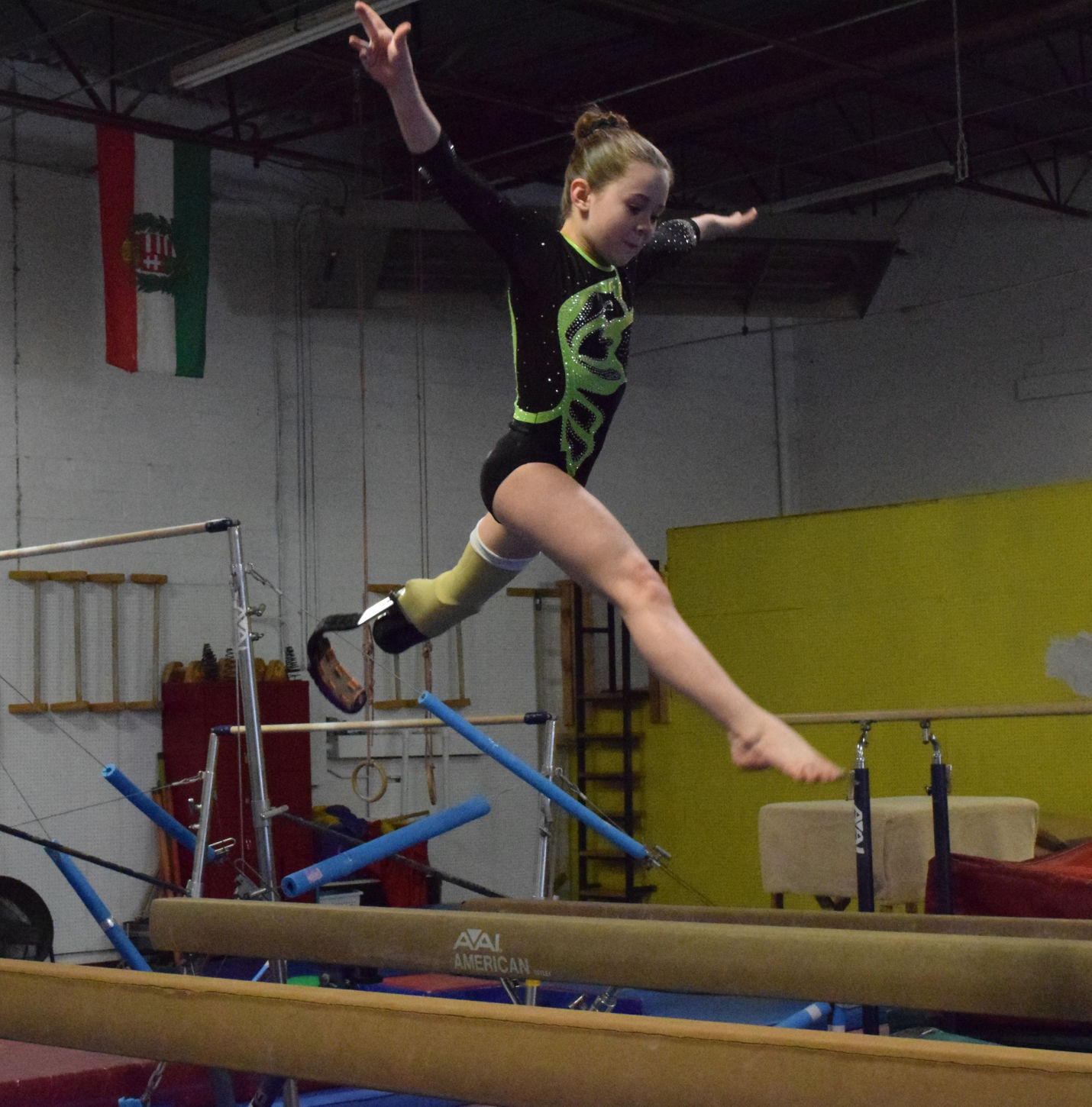 Zoe Smith, 10, performs on the balance beam. Zoe competes with a prosthetic left leg due to her left foot being amputated at age one.